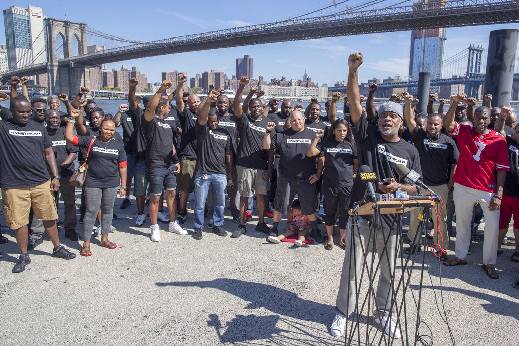 Retired New York City Police Deputy Inspector and author Corey Pegues is surrounded by members of law enforcement as he speaks during a rally to show support for Colin Kaepernick<br>